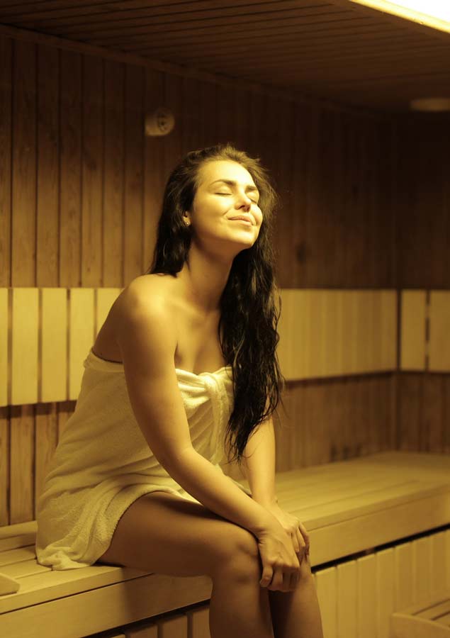 Woman sitting in hot dry sauna KB Day Spa