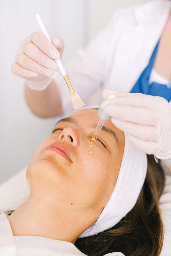 Woman getting a relaxing facial peel