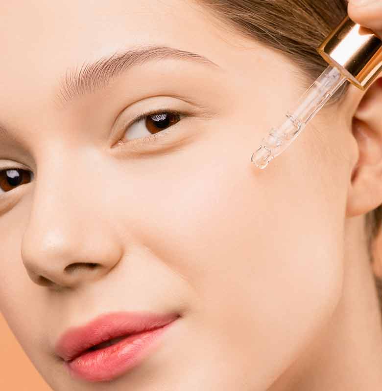 Woman getting facial peel and skincare serum applied at KB Day Spa