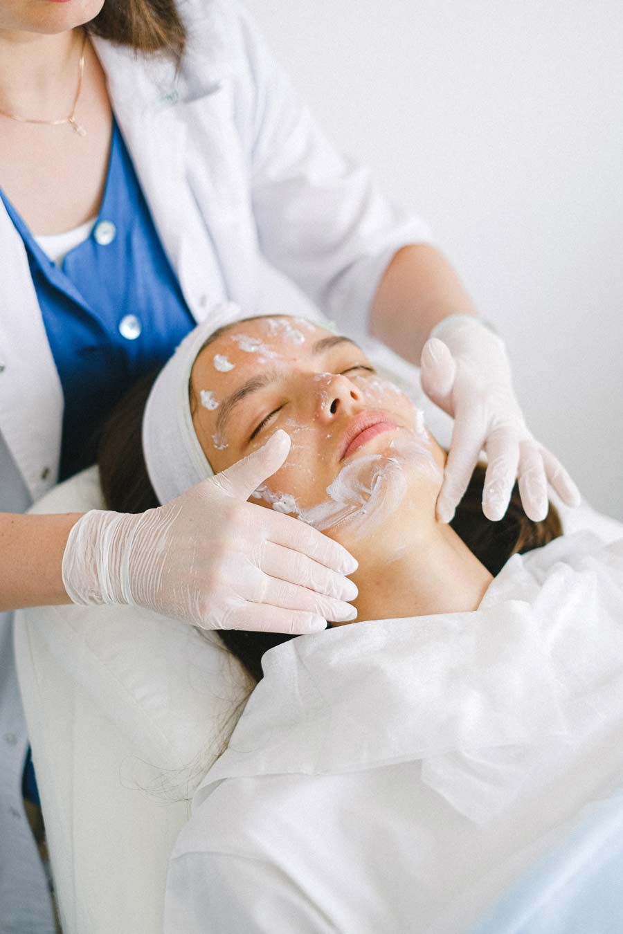 Woman receiving a glycolic acid peel with retinol accelerator